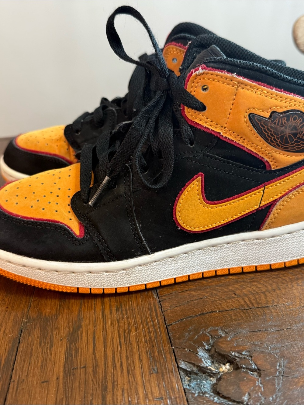 Jordan Kids High-Top Sneakers in Black, Orange, and Pink Accent